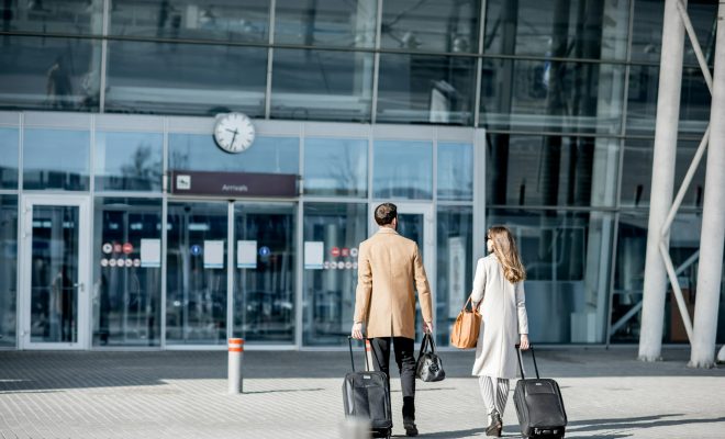 Business couple walking to the airport